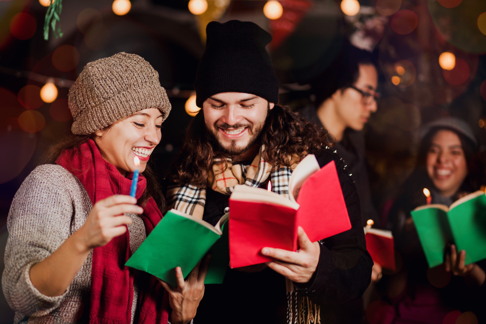 a man and a woman singing Mexican Christmas carols